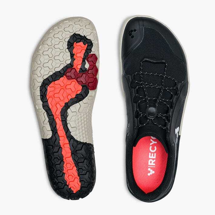 Black Vivobarefoot Primus Trail III trail shoe with red insole and flexible textured sole featuring black, grey, and red.