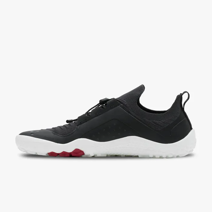 Men's black Vivobarefoot Primus Trail Knit sneaker with white sole and red tread accents.