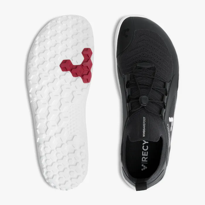 Black knitted athletic shoe with white hexagonal sole and red hexagon detail, lace-up design.