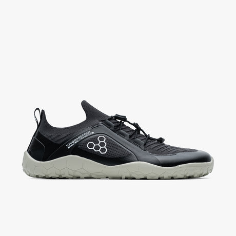 Black and gray lightweight knit trail sneaker with minimalist design and pull tab on heel.