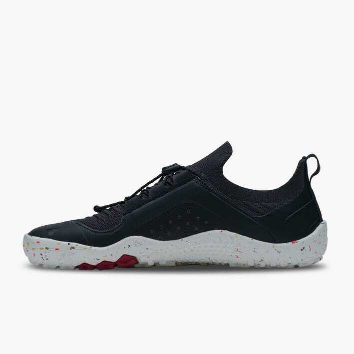 Black knit athletic shoe with white speckled sole and red traction details, low-profile design.