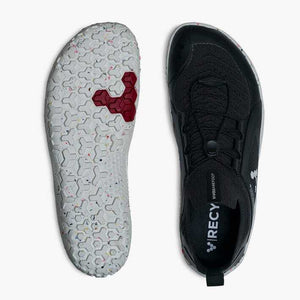 Vivobarefoot men's black Primus Trail Knit shoe with white textured sole and red tread accents.