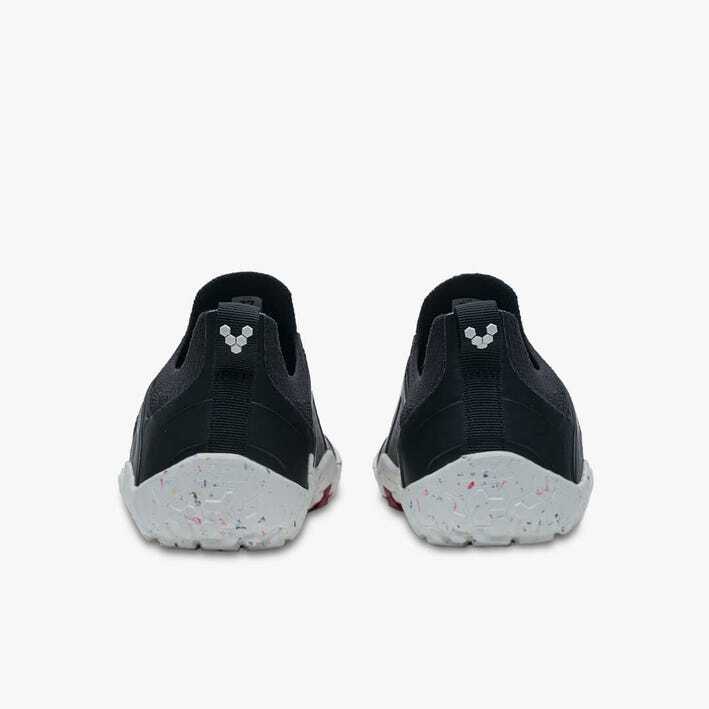 Pair of black and white Vivobarefoot men's athletic shoes shown from the back with textured white soles.