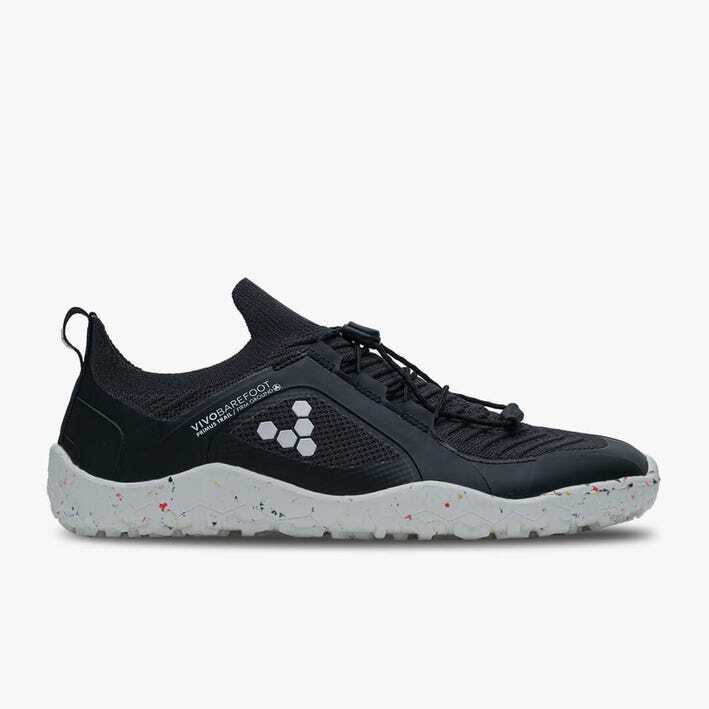 Black and white knit trail sneaker with flexible sole and pull tab on heel.