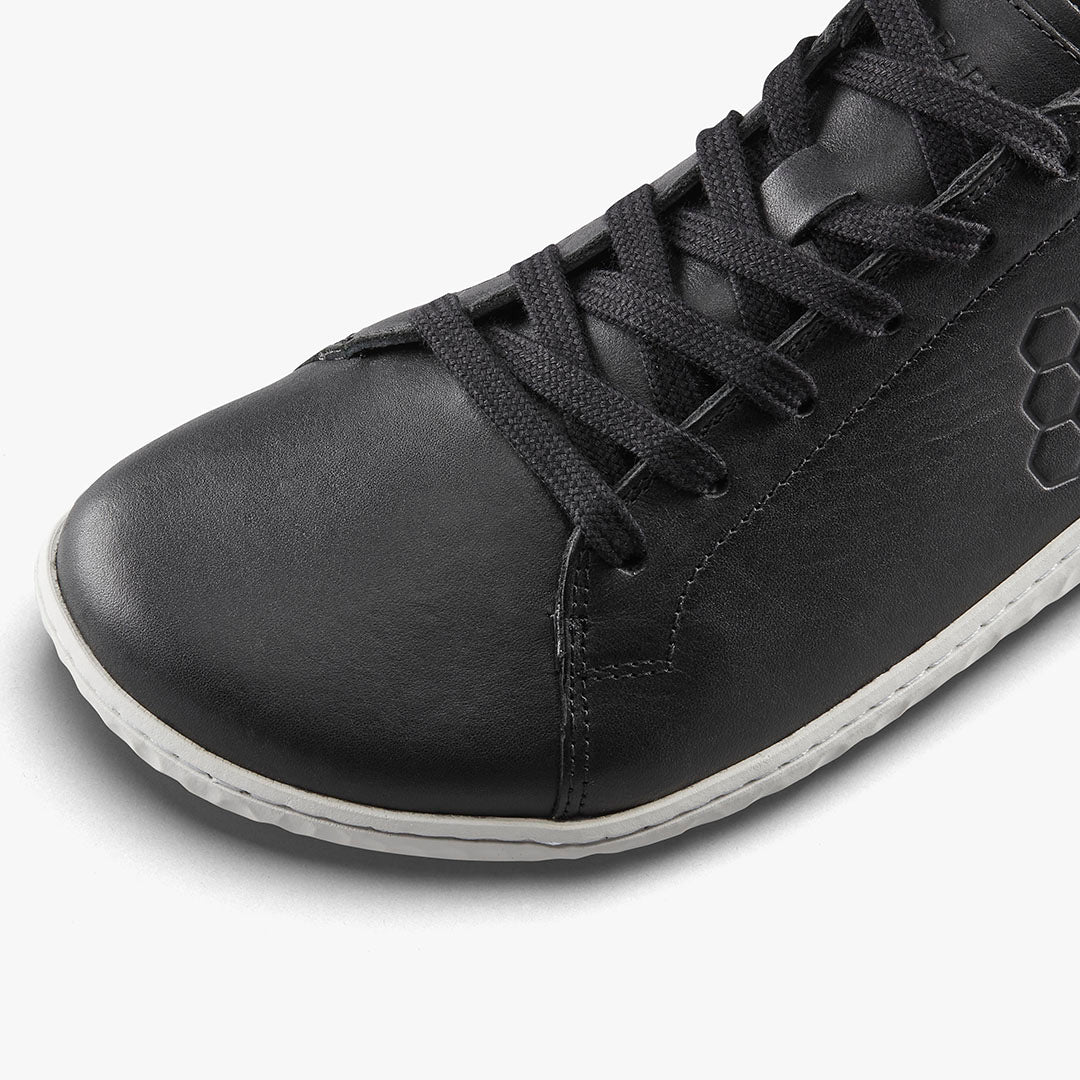 Black leather Vivobarefoot Geo Court III sneaker with hexagonal logo and white sole detail.