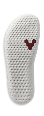 White textured shoe sole with a red hexagonal logo near the ball of the foot.