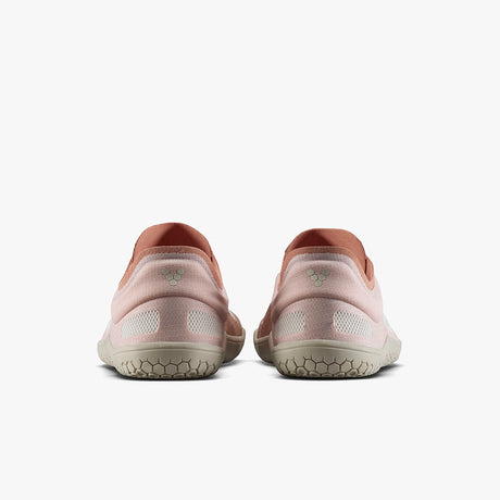 Pair of dusty rose athletic shoes with textured beige soles, viewed from the back.