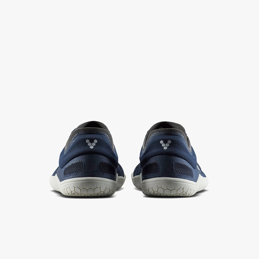 Pair of midnight blue athletic shoes with grey soles and subtle logo on heels, viewed from back.