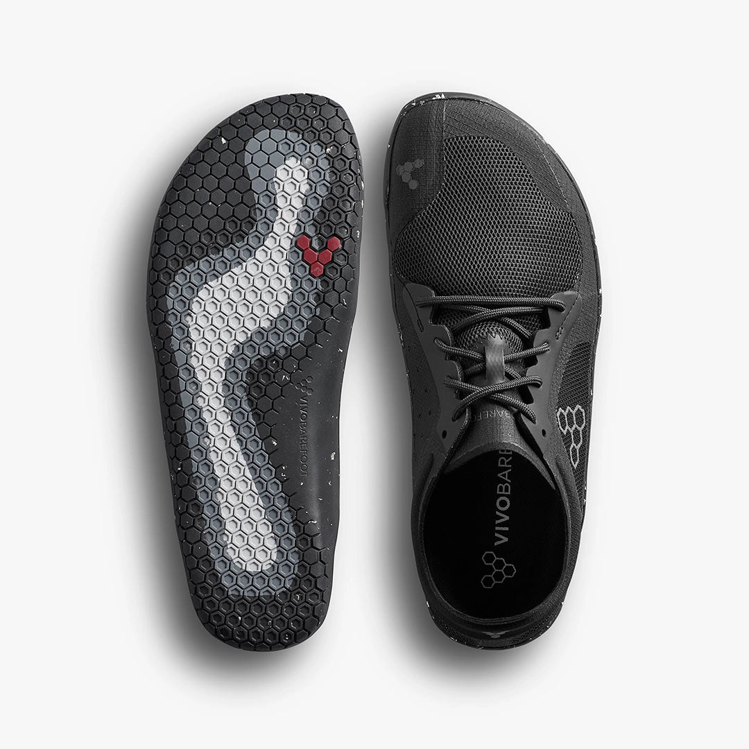 Black Vivobarefoot Primus Lite 3.5 athletic shoe with breathable mesh upper and flexible hexagonal sole pattern.