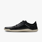 Black low-profile athletic shoe with white sole and minimalist design, featuring "Vivobarefoot" branding on the side.