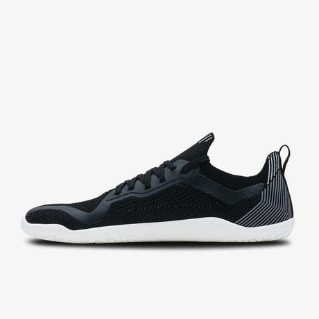 Black and white women's lightweight athletic shoe with knit upper and minimalist sole.
