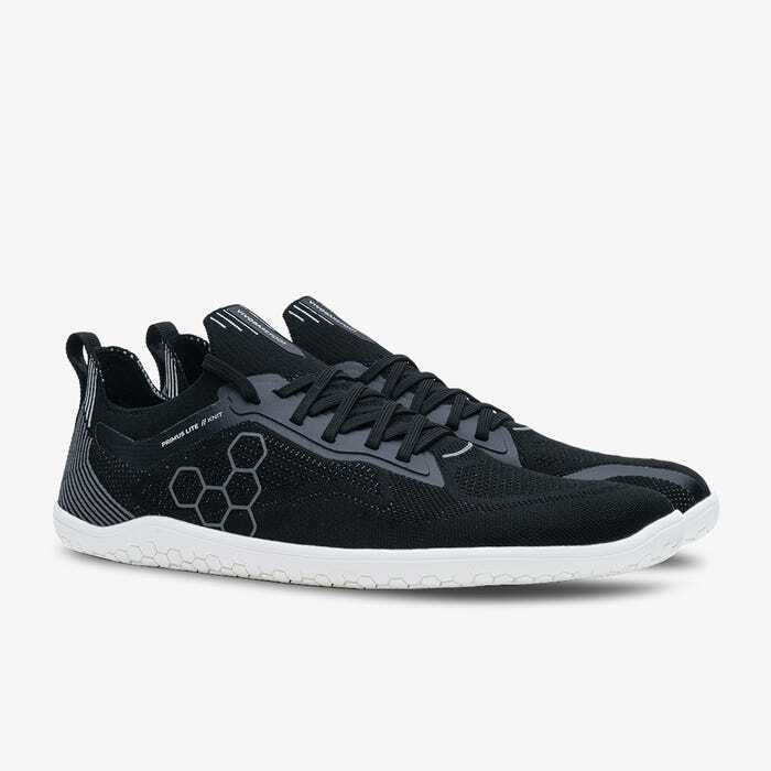 Black knit athletic shoes with hexagonal pattern and white textured sole.
