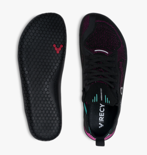 Black and vibrant pink knitted athletic shoe with flexible sole and honeycomb insole pattern.