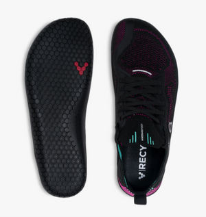 Black and vibrant pink knitted athletic shoe with flexible sole and honeycomb insole pattern.