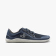 Navy blue athletic shoe with mesh upper, grey honeycomb logo, white textured sole, and lace-up design.