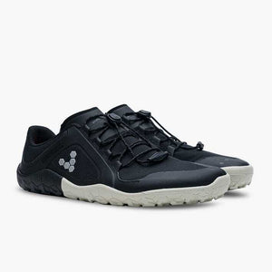 Black low-profile athletic shoes with beige soles, elastic lacing, and reflective logo on side.