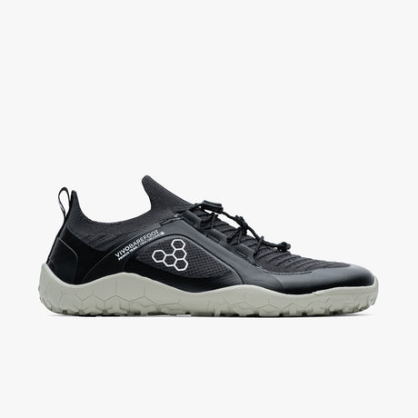 Black and gray knit low-top trail shoe with hexagonal pattern logo and elastic laces.