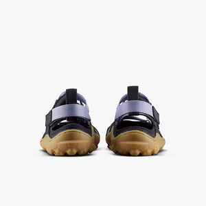 Pair of purple heather Vivobarefoot women's Tracker sandals with black straps and rugged tan soles shown from the back.
