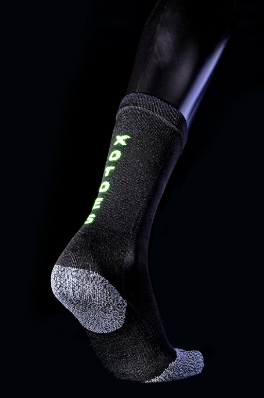 Black and grey crew sock with neon green XOTOES™ logo on side, cushioned heel and toe.