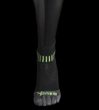 Black quarter crew toe socks with green accents and "XOSKIN" logo on the toes.