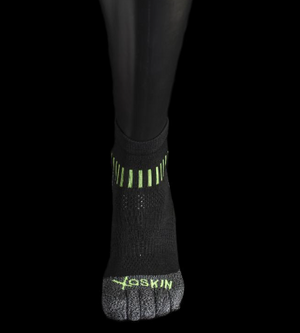 Black quarter crew toe socks with green accents and "XOSKIN" logo on the toes.