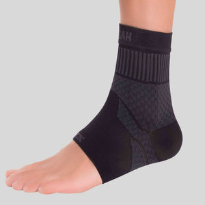 Black compression ankle sleeve with ribbed cuff and textured support panels on foot and ankle.