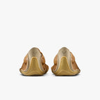 Back view of brown leather shoes with a white background