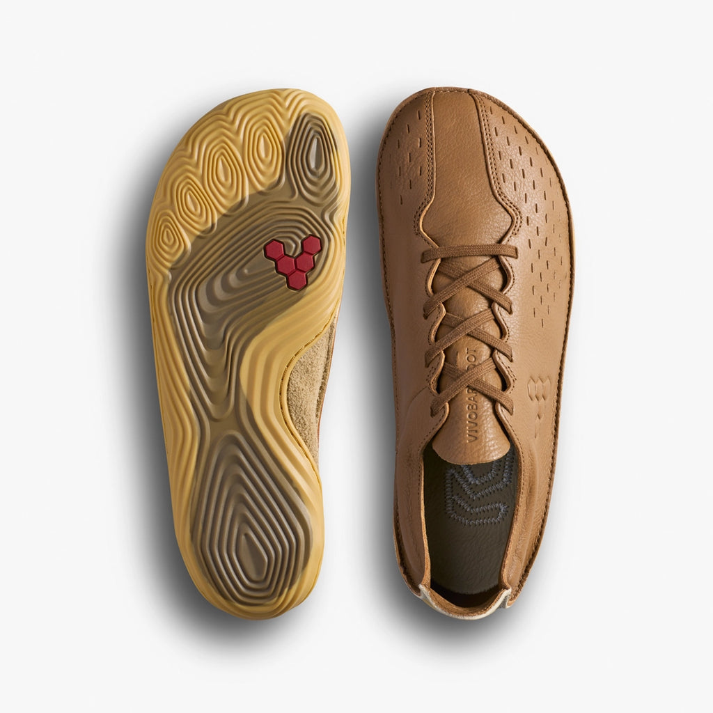 Tan shoe with a red logo on the sole, displayed on a light gray background.